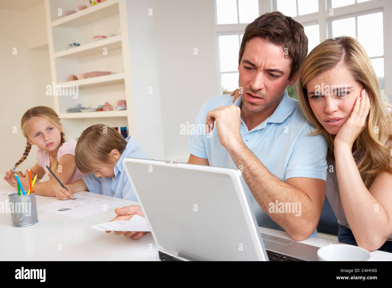 Young couple thinking and looking at a laptop computer Stock Photo