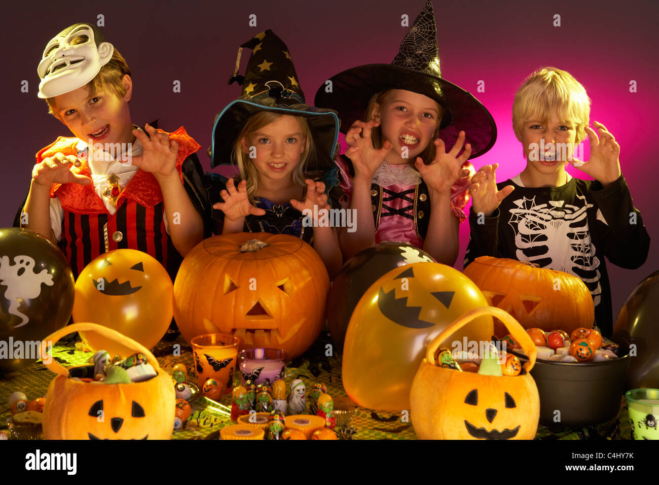 Halloween party with children wearing fancy costumes Stock Photo