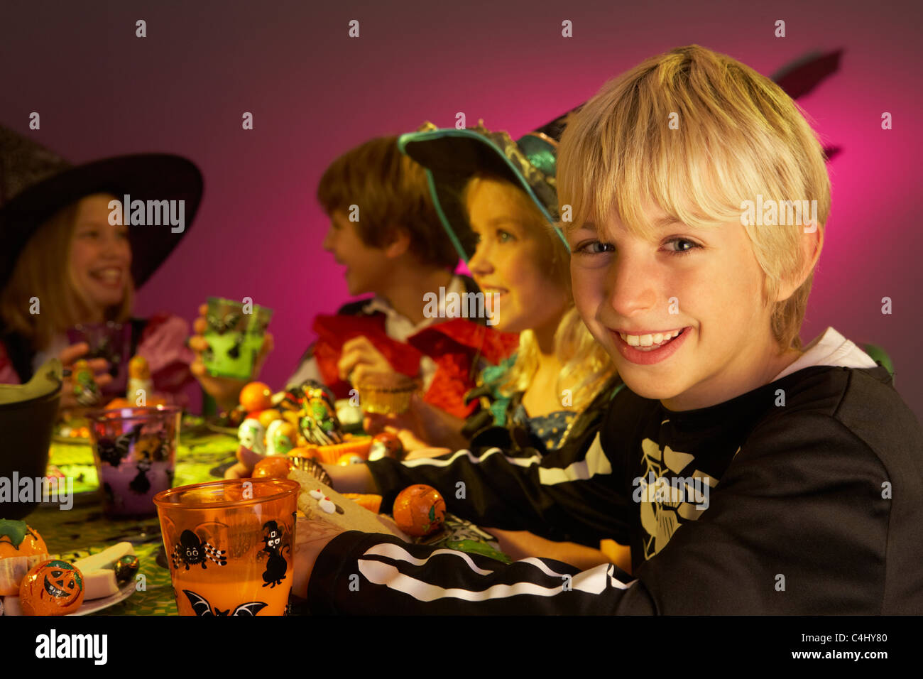 Halloween party with children having fun in fancy costumes Stock Photo