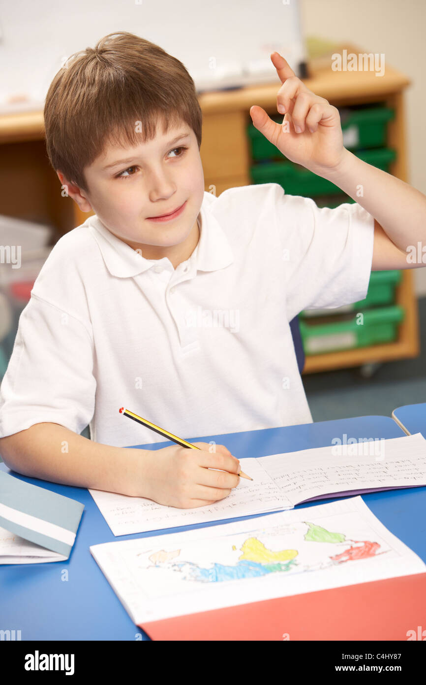 Schoolboy Studying In Classroom Stock Photo
