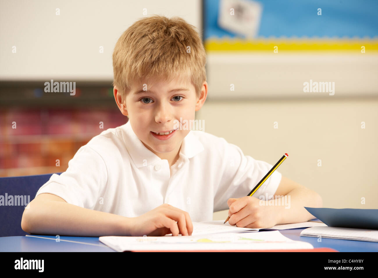 Schoolboy Studying In Classroom Stock Photo - Alamy