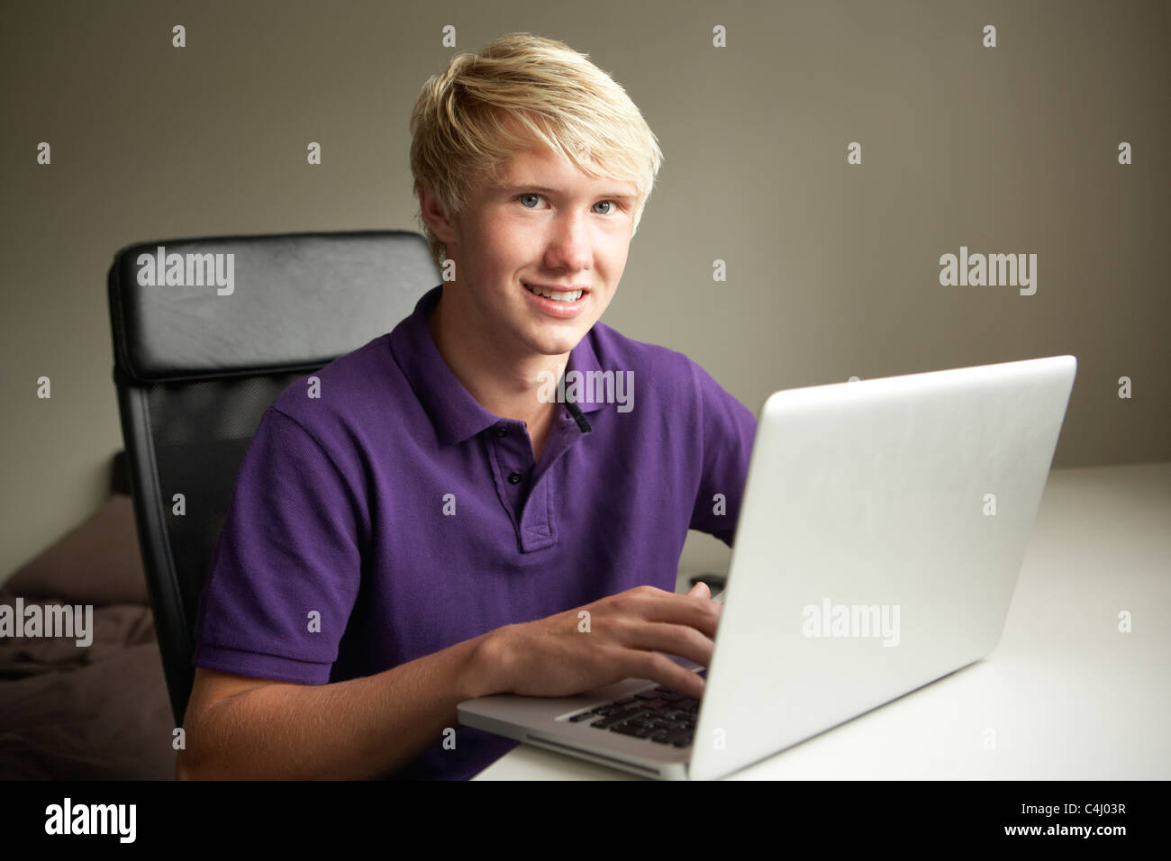 Teenage Boy Using Laptop At Home Stock Photo - Alamy