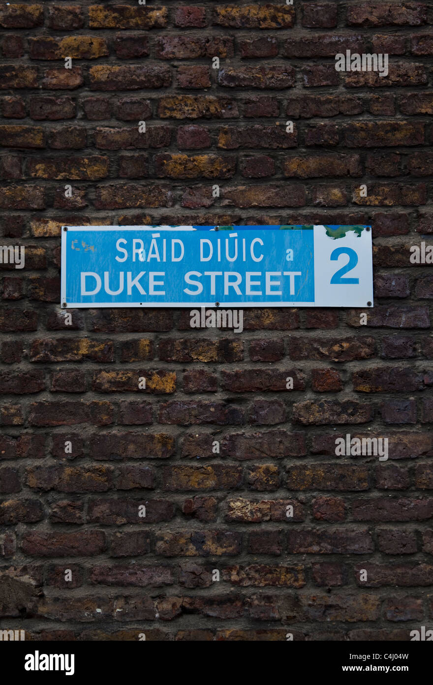 Official street sign for Duke St. on redbrick wall in Dublin city centre, Ireland Stock Photo