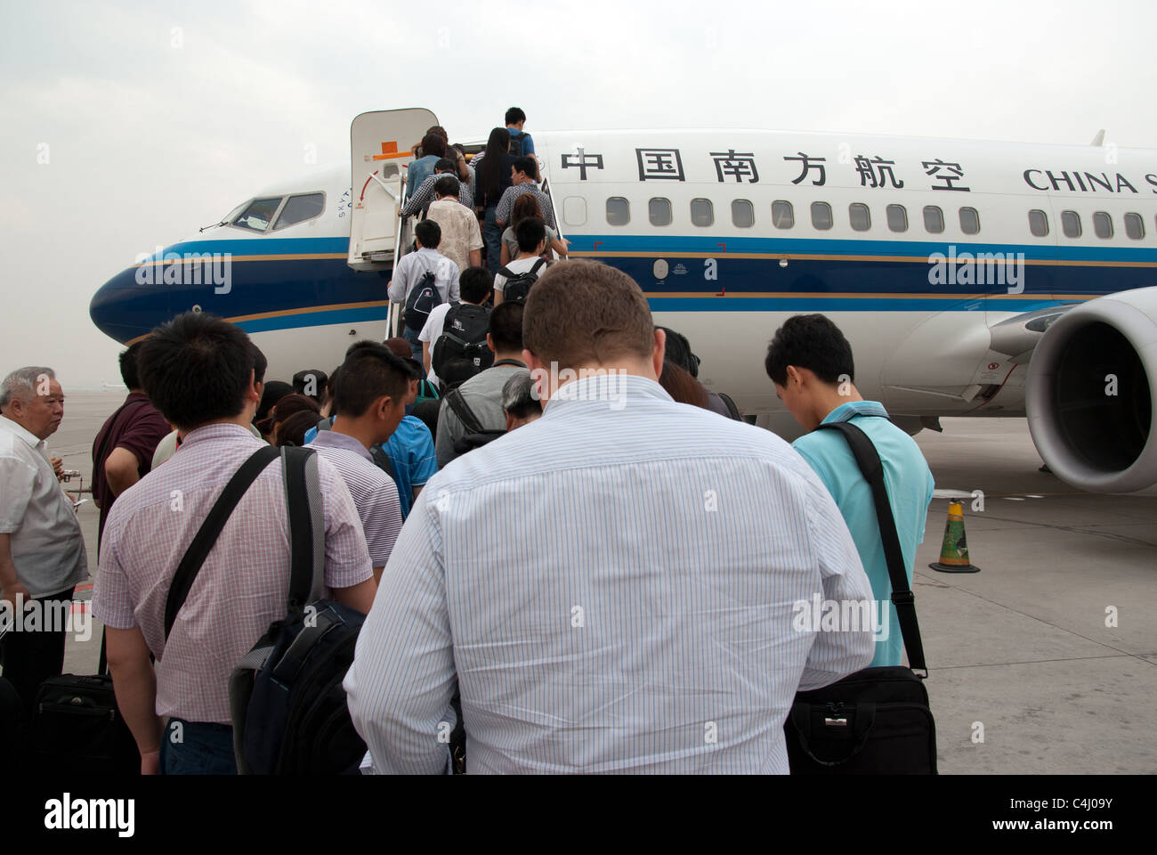 Travelers boarding China Southern Airlines plane Stock Photo