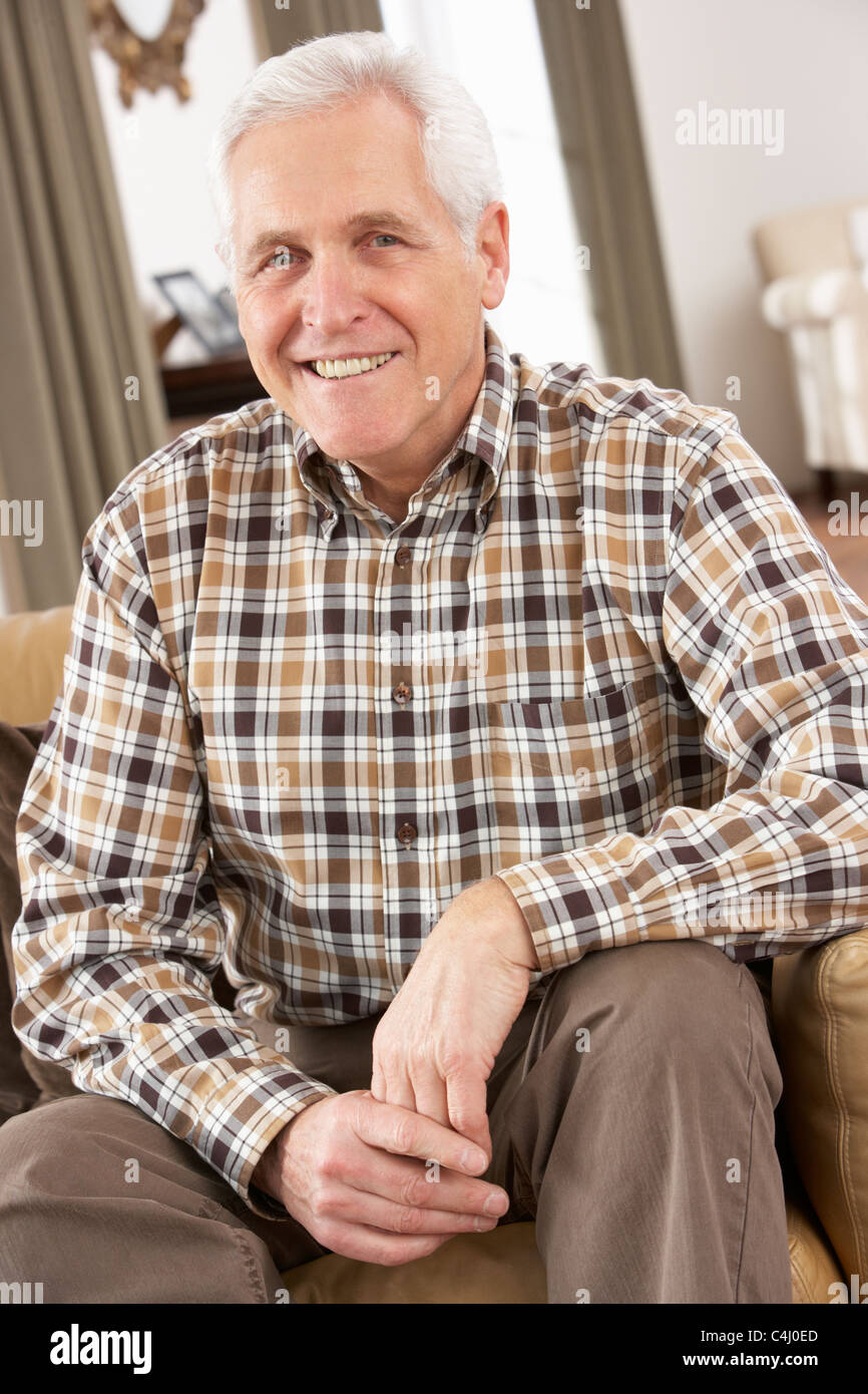 Senior Man Relaxing In Chair At Home Stock Photo - Alamy