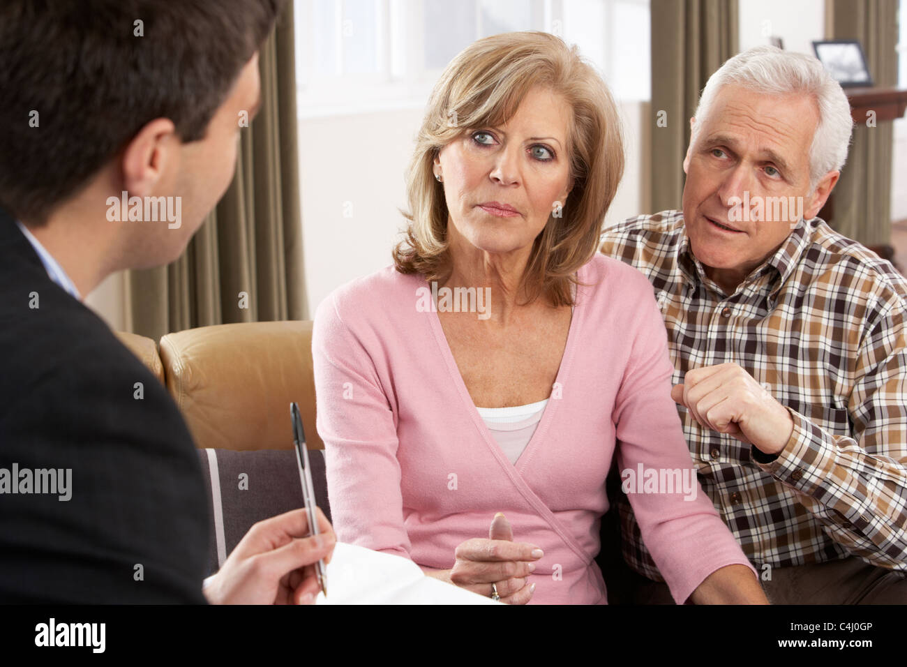 Senior Couple Talking With Financial Advisor Stock Photo