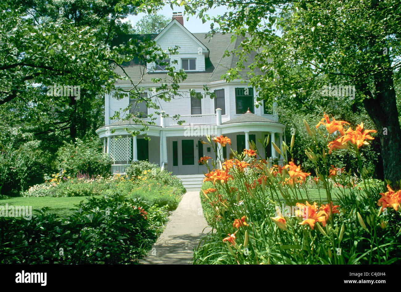 Victorian House Painted White With Blooming Gardens And Day Lilies Stock Photo Alamy