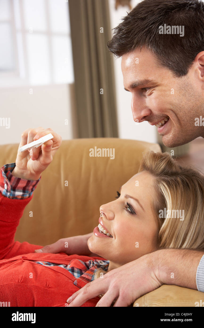 Couple Looking At Result Of Home Pregnancy Test Kit Stock Photo
