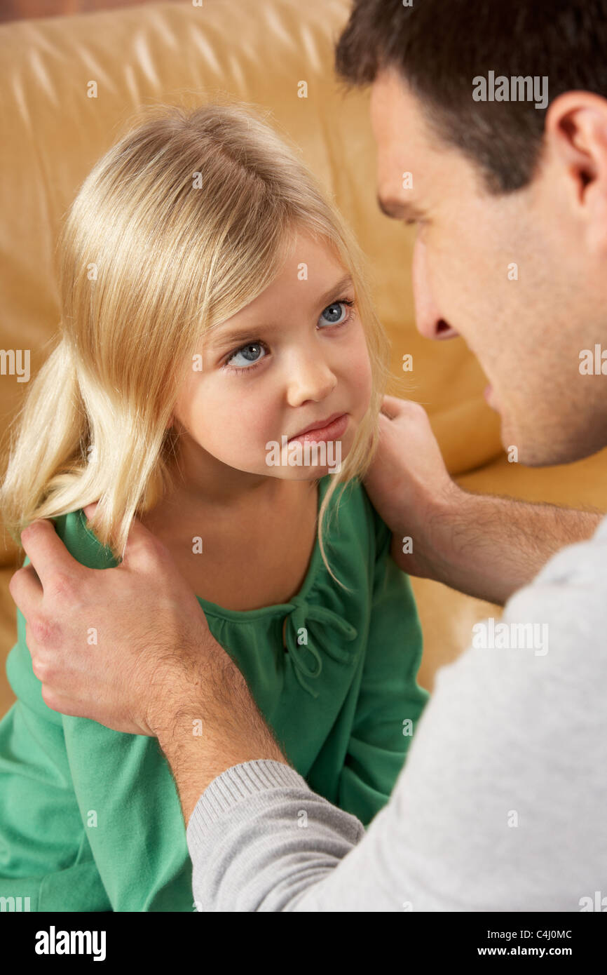 Portrait Of Frightened Daughter Looking At Father Stock Photo