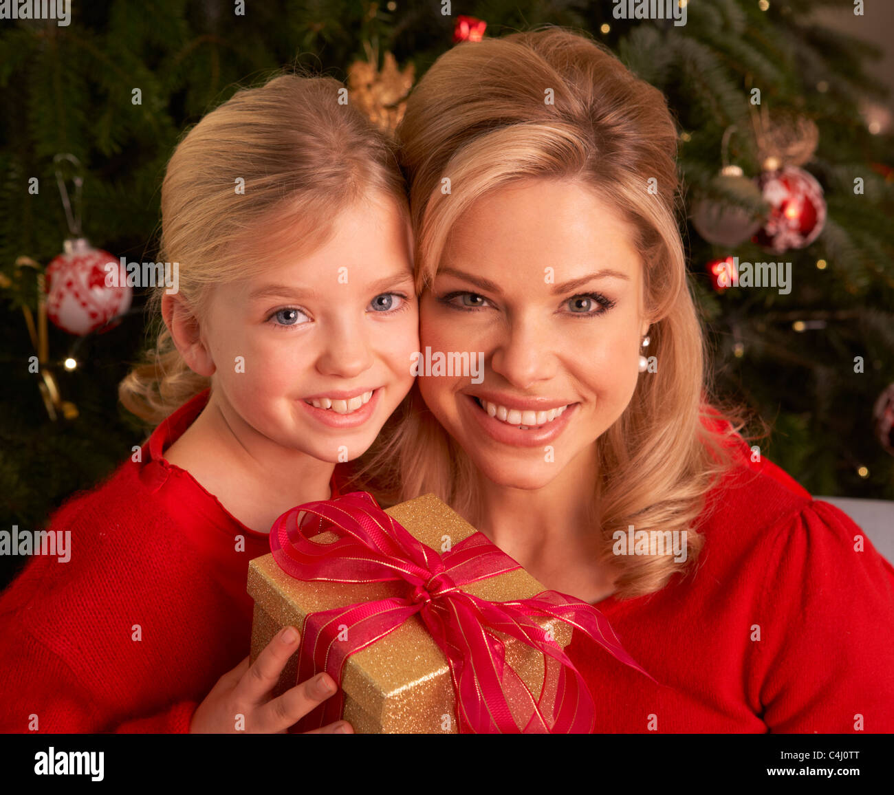 Daughter Giving Mother Christmas Gift Stock Photo