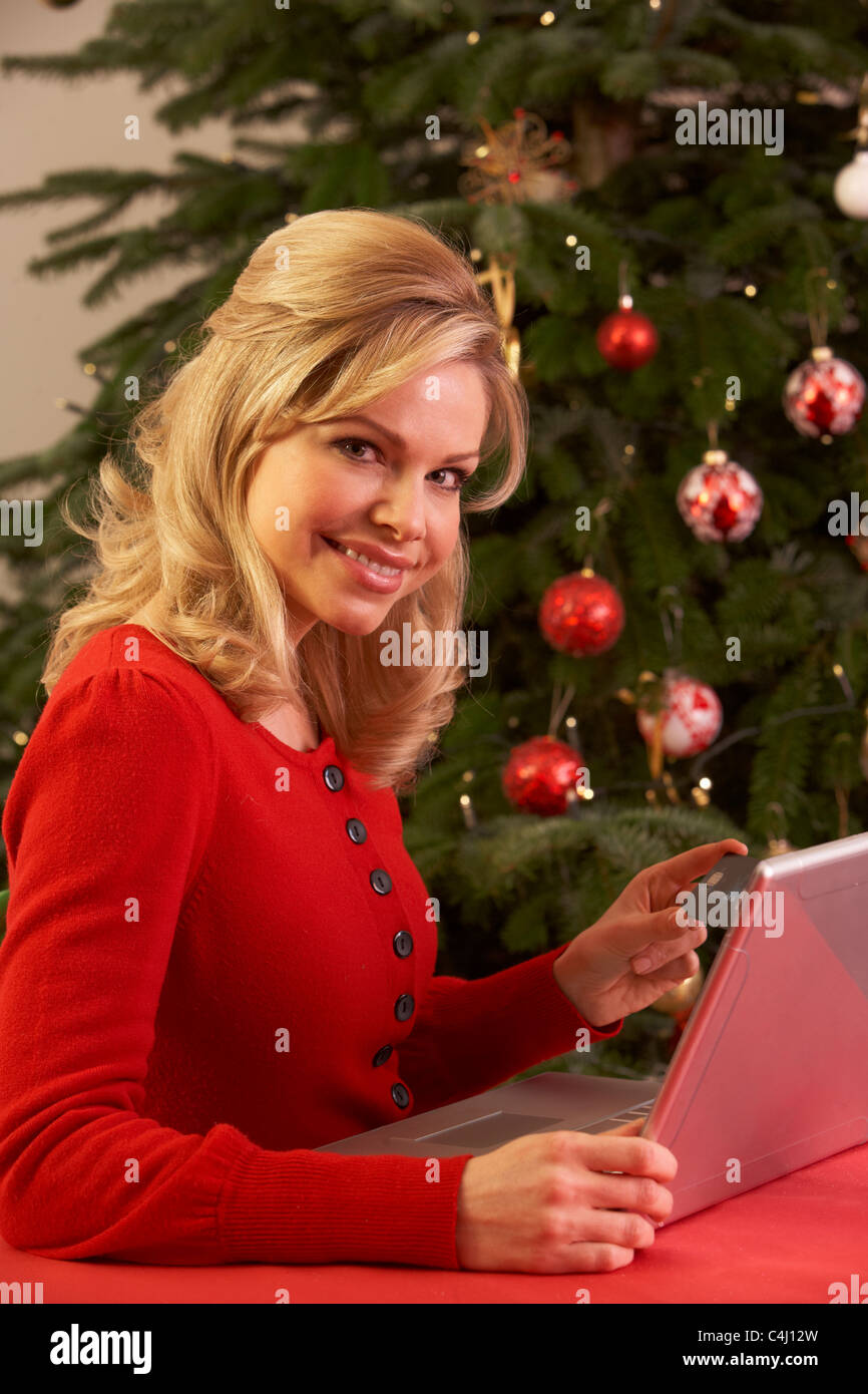 Woman Shopping Online For Christmas Gifts Stock Photo