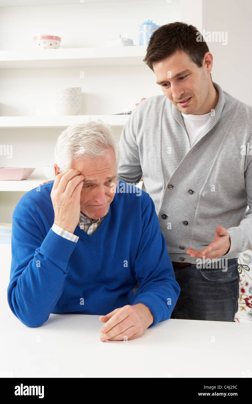 Grown Up Son Consoling Senior Parent Stock Photo