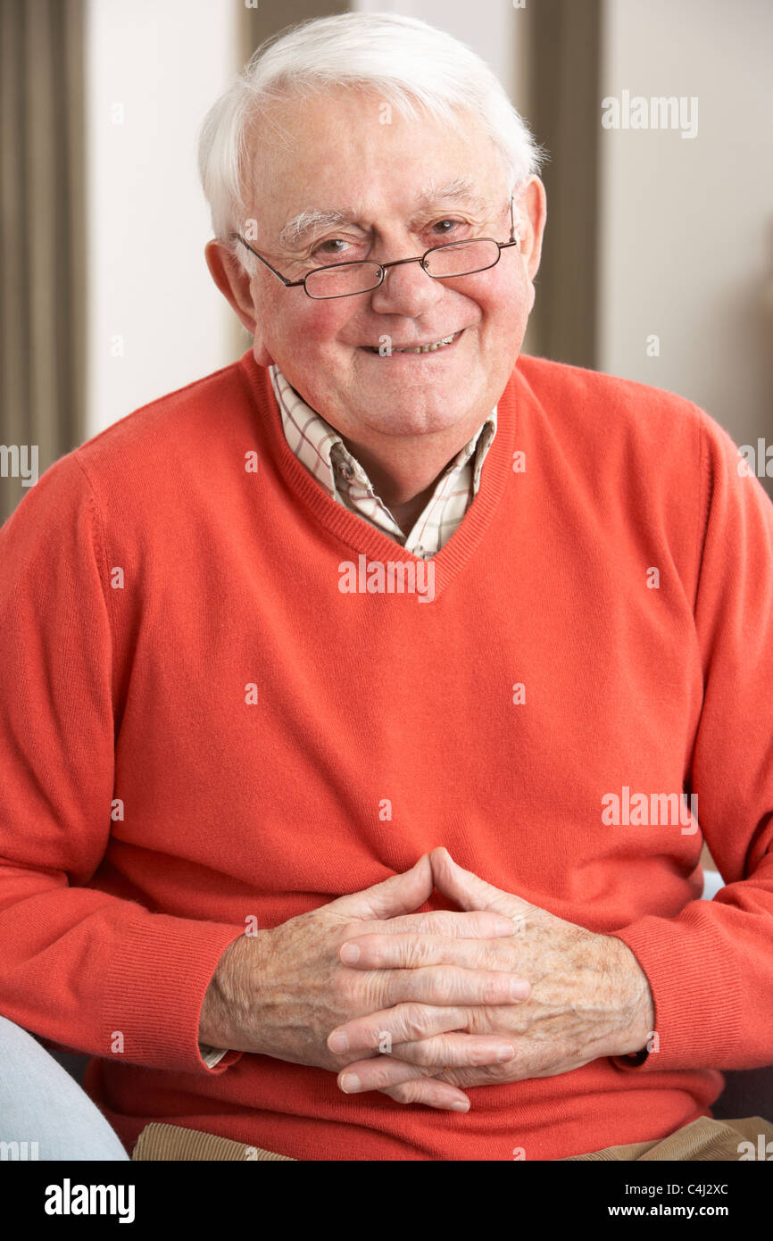 Senior Man Relaxing In Chair At Home Stock Photo - Alamy