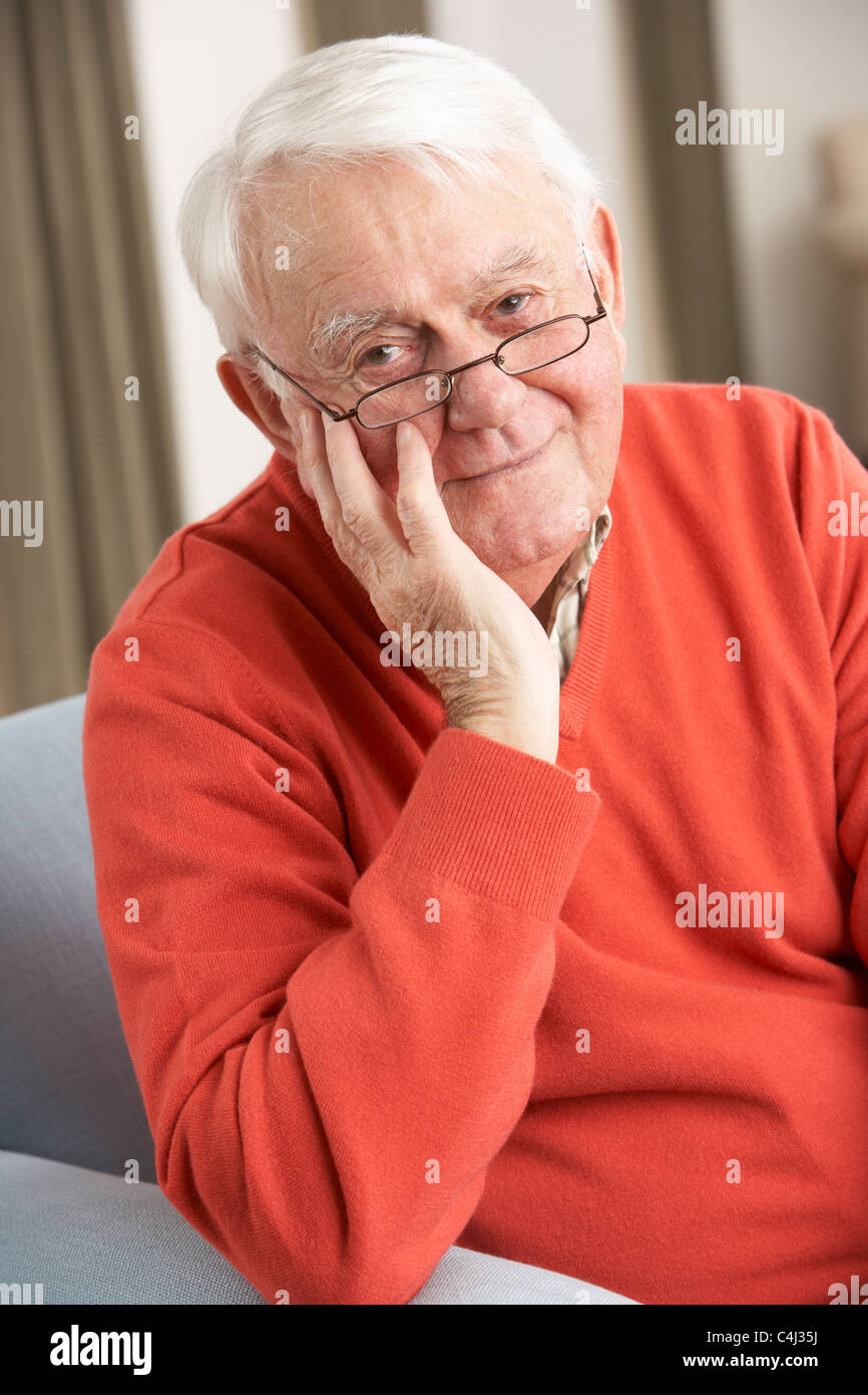 Senior Man Relaxing In Chair At Home Stock Photo - Alamy