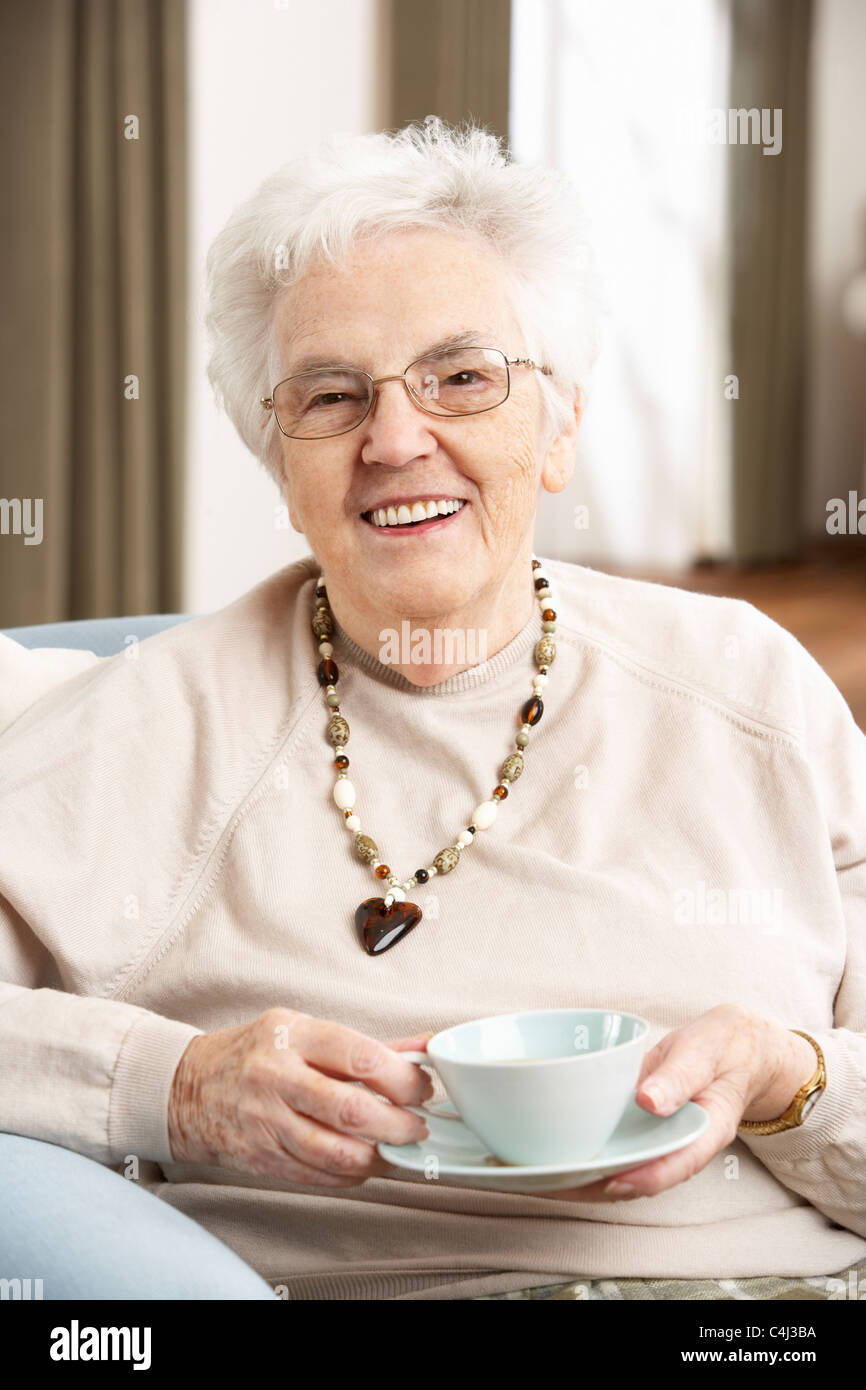 Senior Woman Enjoying Cup Of Tea At Home Stock Photo - Alamy