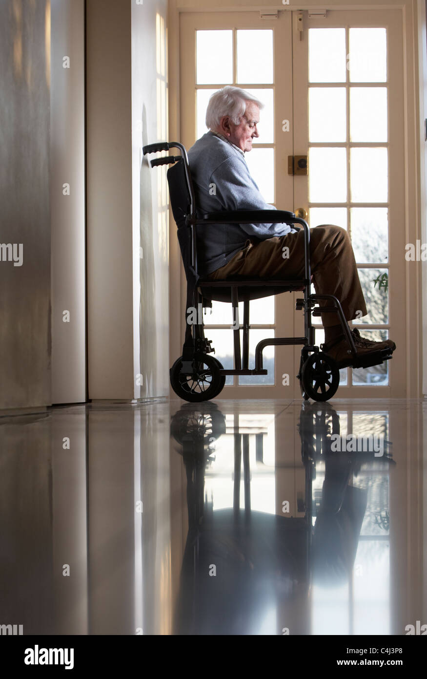 Disabled Senior Man Sitting In Wheelchair Stock Photo