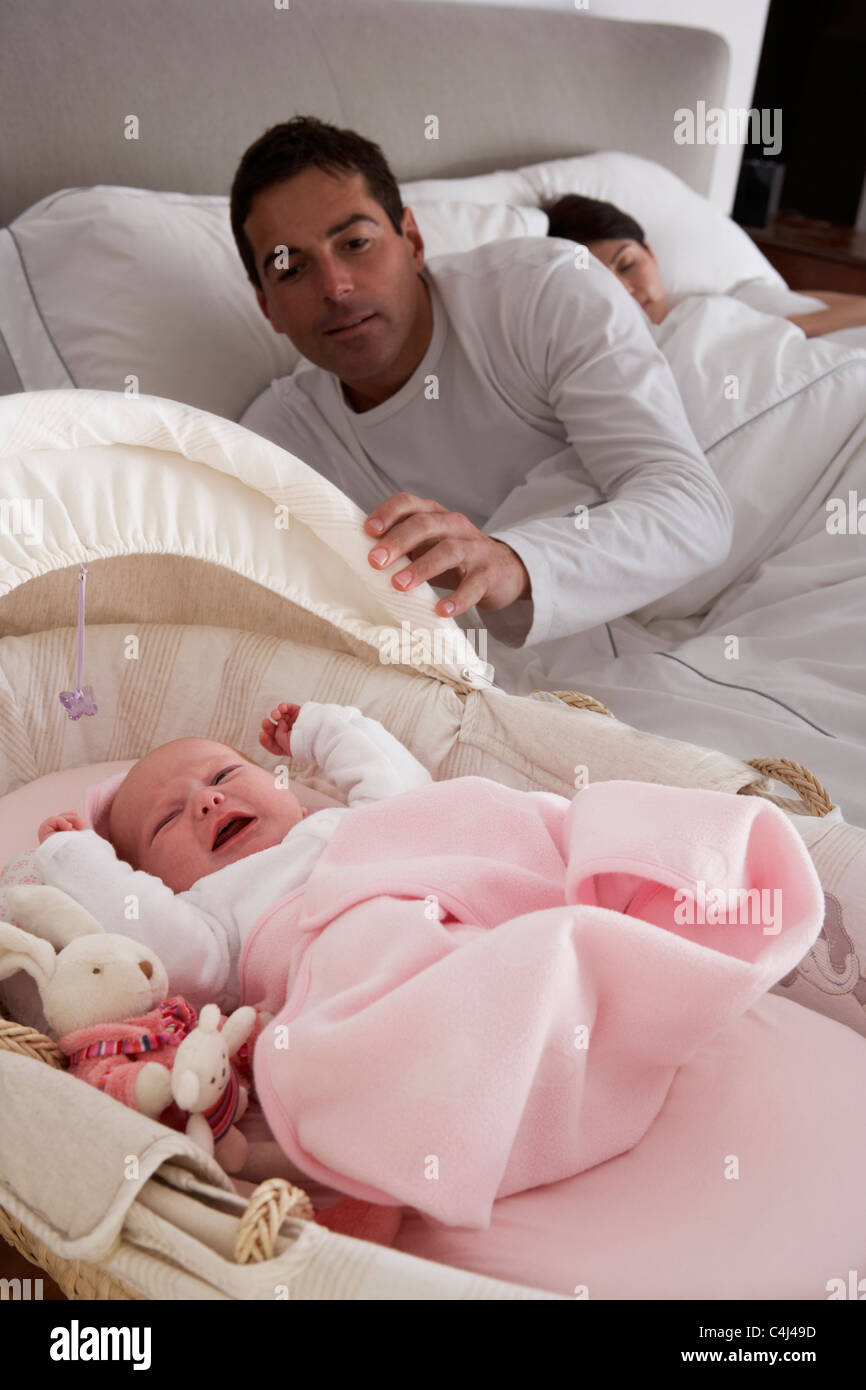 Newborn Baby Crying In Cot In Parents Bedroom Stock Photo