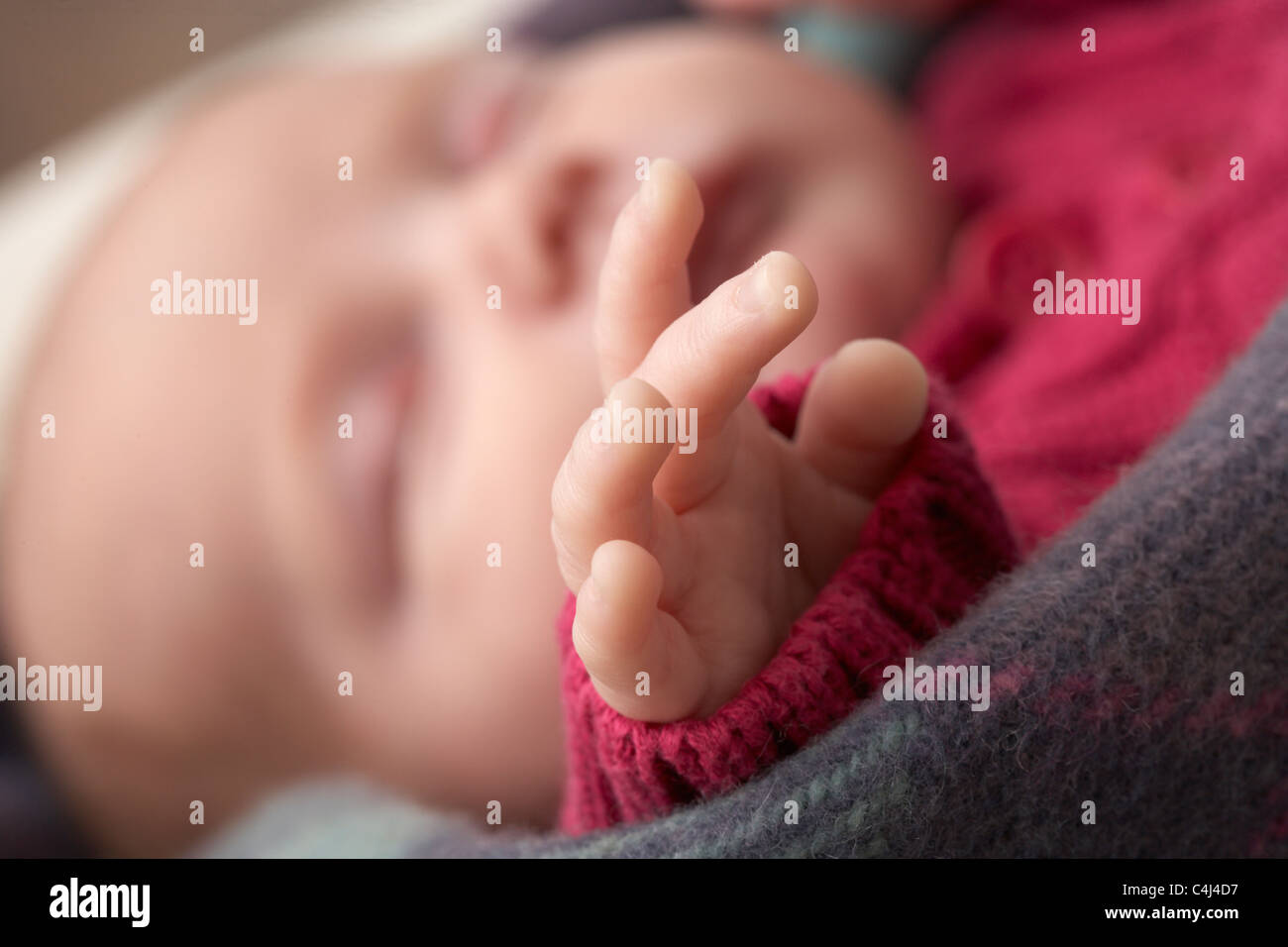 Close Up Of Hand Of Sleeping Newborn Baby Girl Stock Photo
