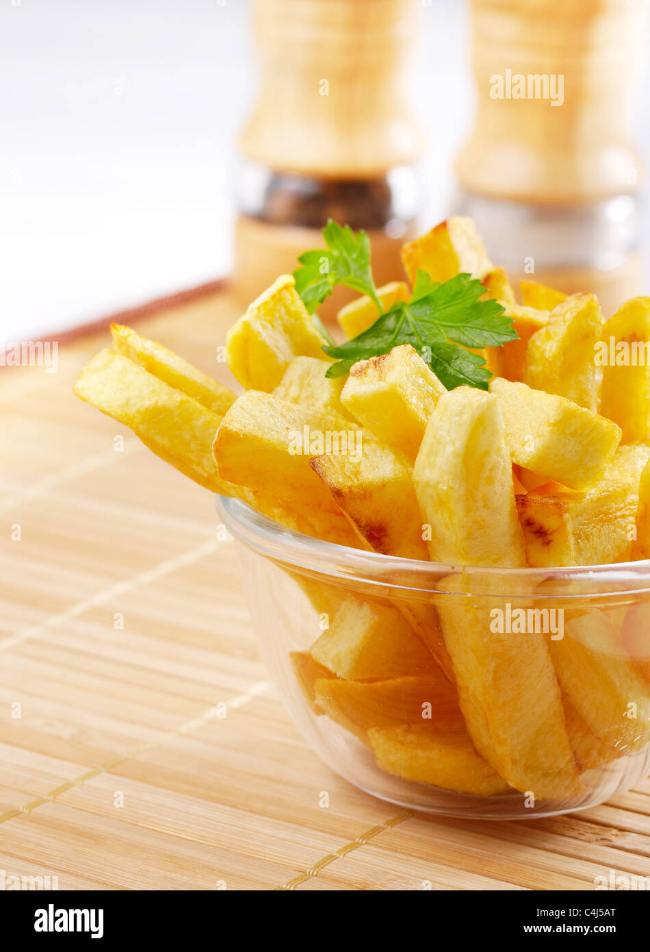 French fries in the glass bowl on the wooden table Stock Photo