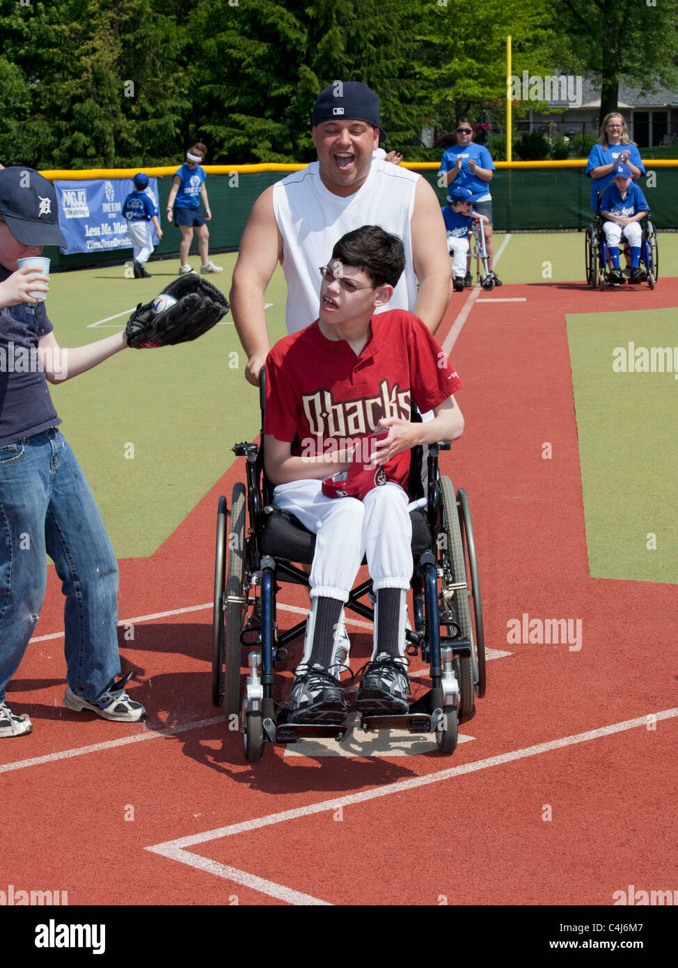 Children with Disabilities Play Baseball in the Miracle League Stock Photo
