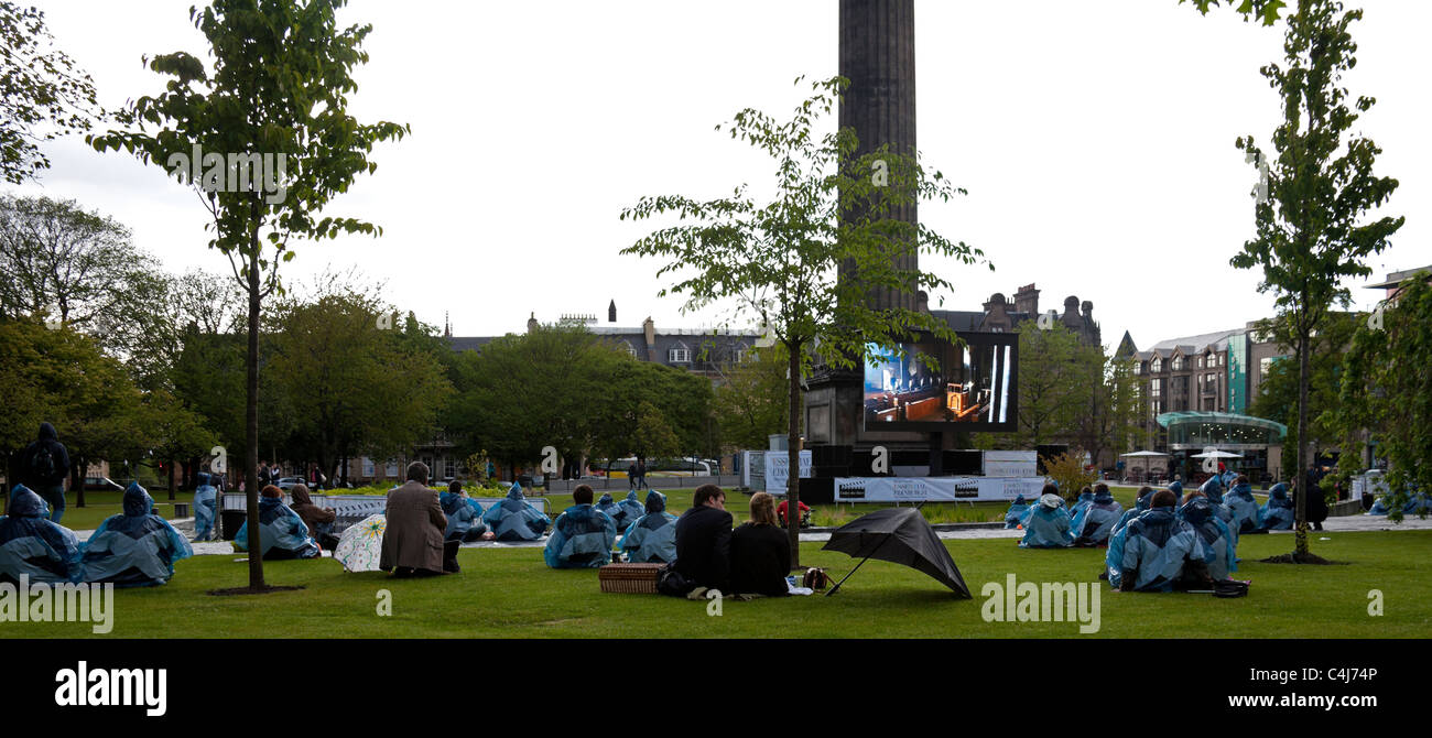 2011 Edinburgh Film Festival St Andrews Square outdoor screenings, braving the rain shower while viewing Da Vinci Code Stock Photo