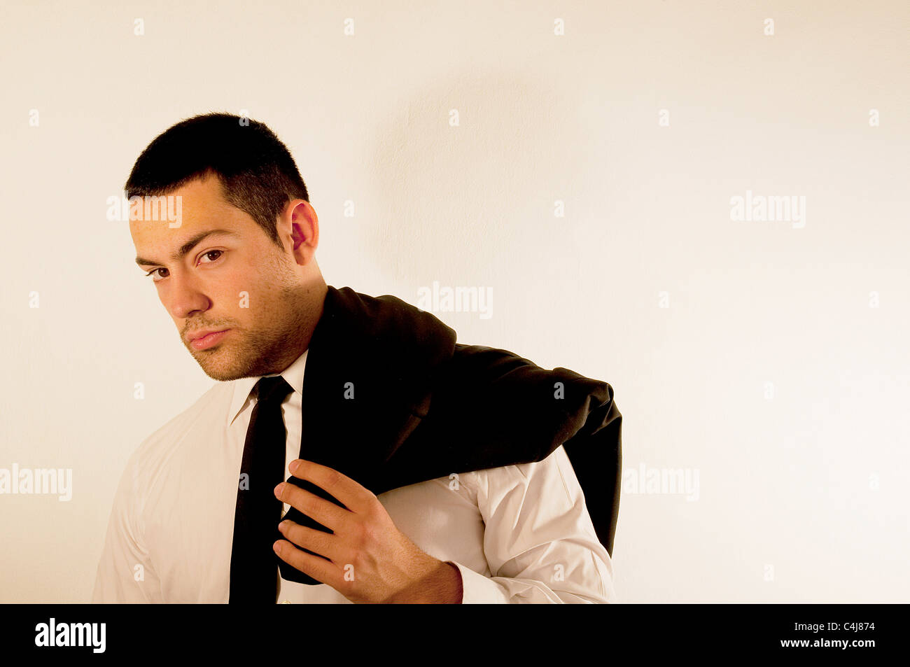 Young man with jacket on his shoulder. Stock Photo