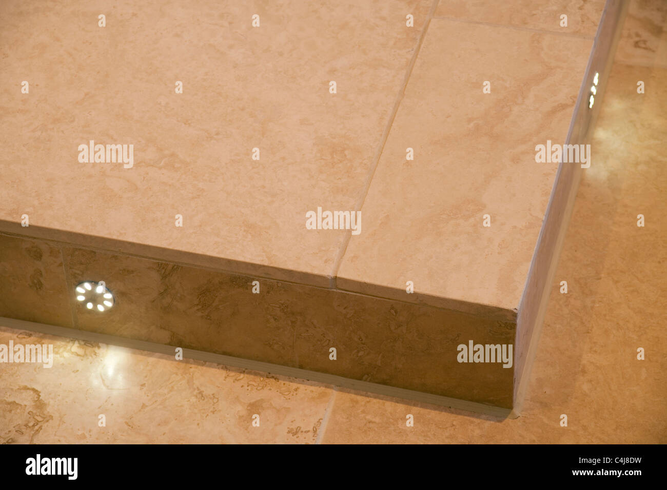 Limestone bathroom floor with inset LED lights. Stock Photo