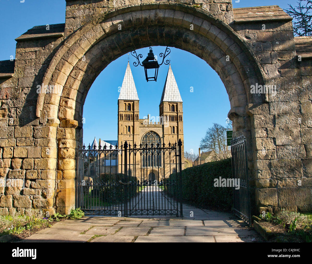 Southwell Minster in Nottinghamshire with unusual pepper pot towers viewed through the romanesque entrance gateway Stock Photo