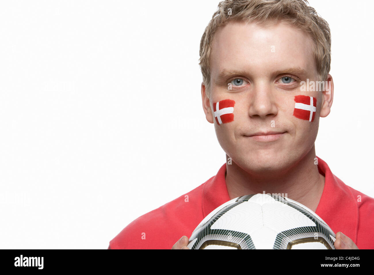 Young Male Football Fan With Danish Flag Painted On Face Stock Photo