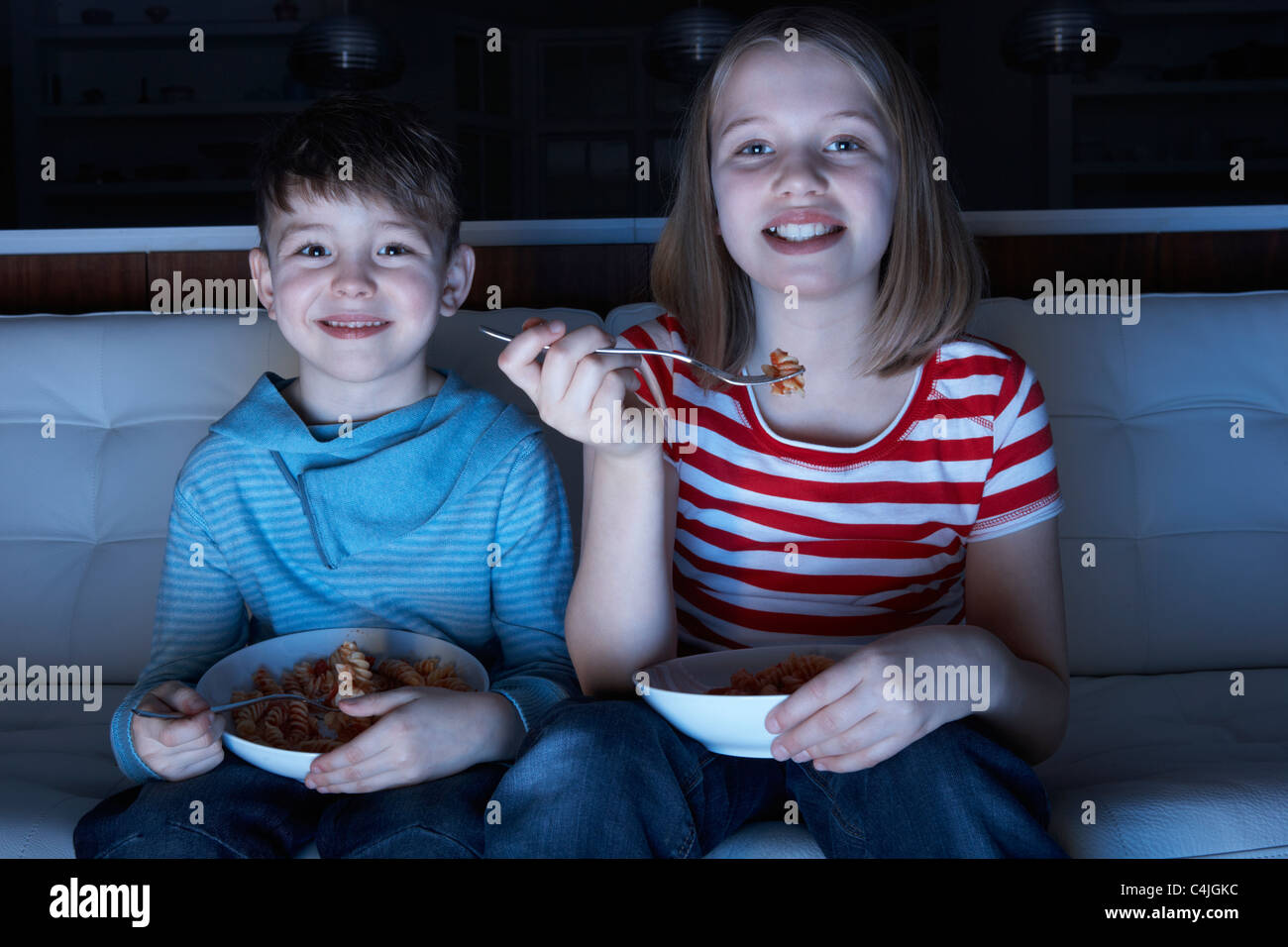 Children Enjoying Meal Whilst Watching TV Stock Photo Alamy