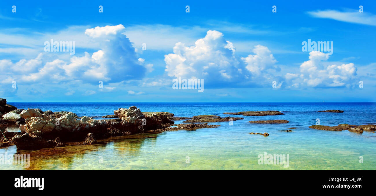 Blue beach landscape with Mediterranean sea & cloudy sky Stock Photo