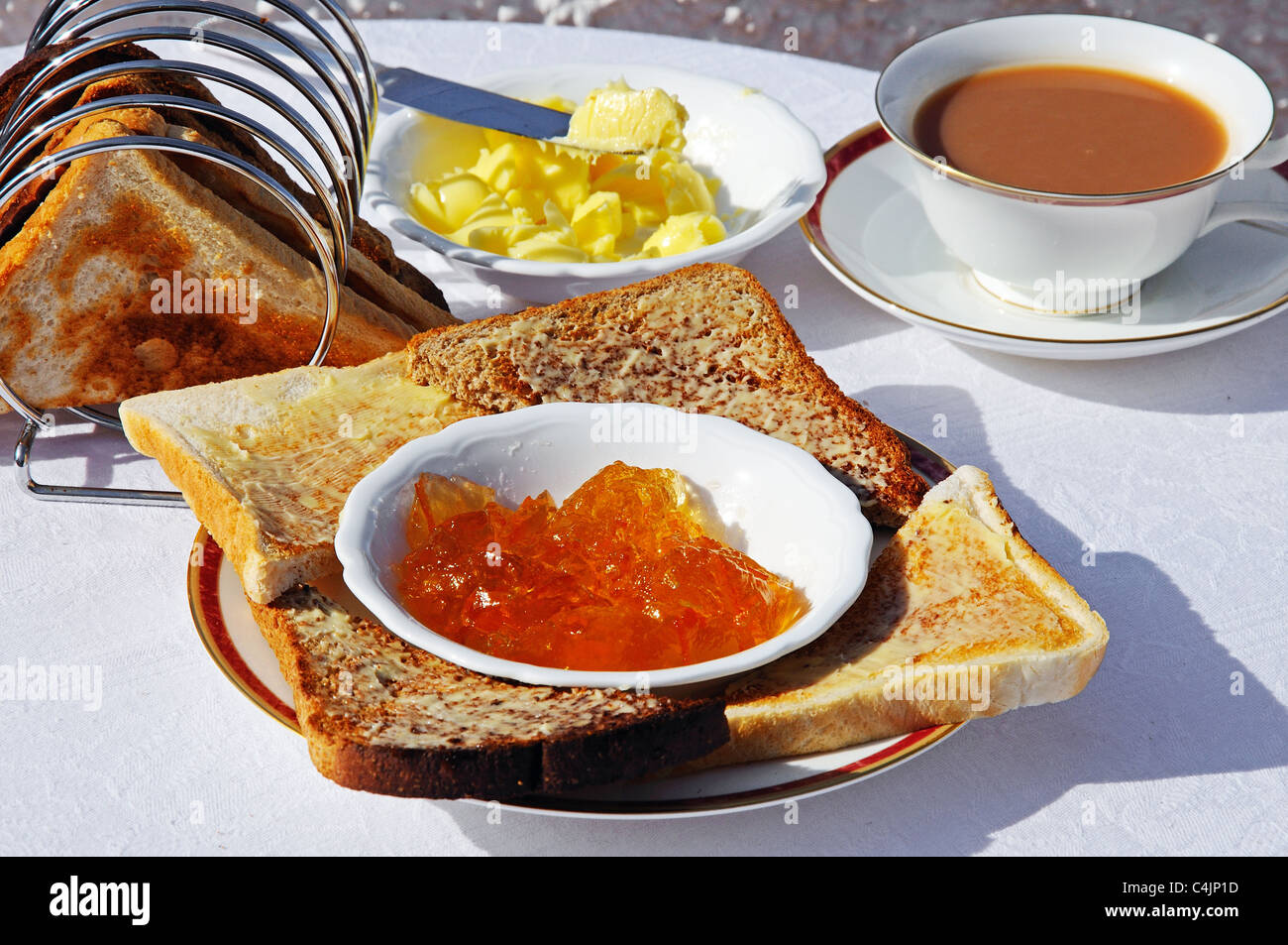Buttered toast and marmalade with cup of tea to the rear, Western