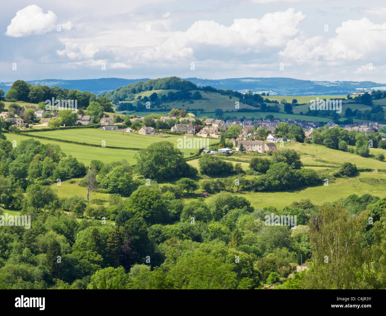 View over Woodchester and rolling English Cotswold countryside near Stroud, Gloucestershire, with Malvern Hills in the distance. Stock Photo