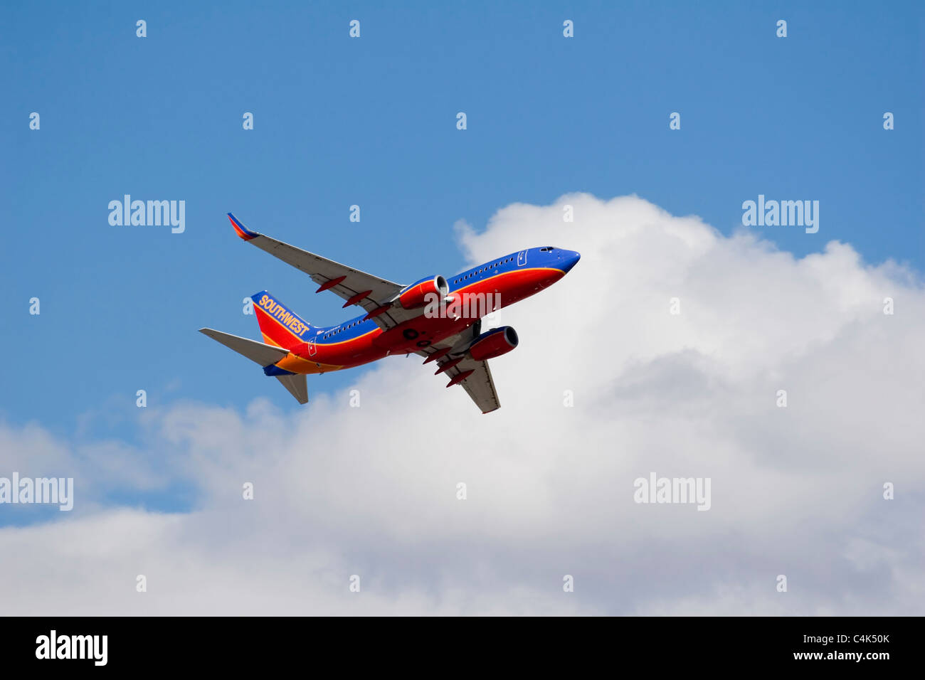 A Southwest Airlines passenger jet departs Denver International Airport amongst some clouds and
