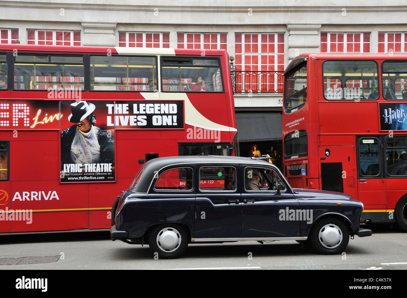 Red double decker buses and black cab on Regent Street, London. Stock Photo