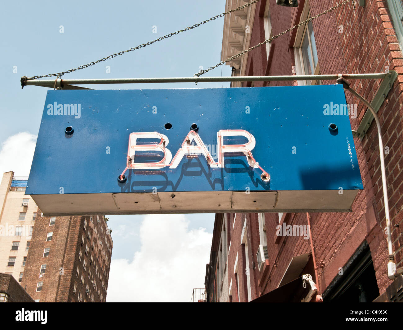 retro neon bar sign with lettering applied to repainted blue base of