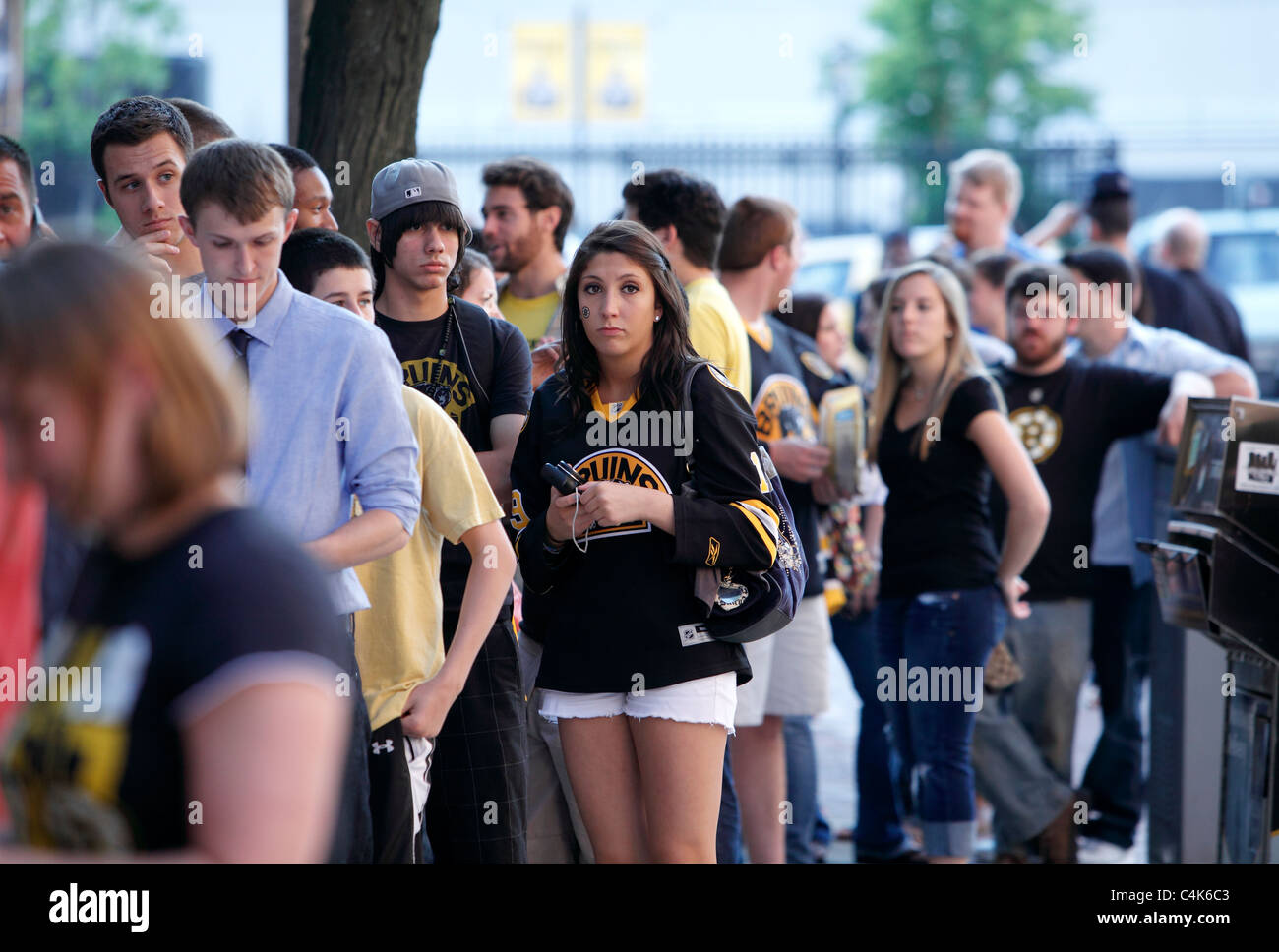 Boston Bruins hockey fans line up to enter a bar in Boston for game