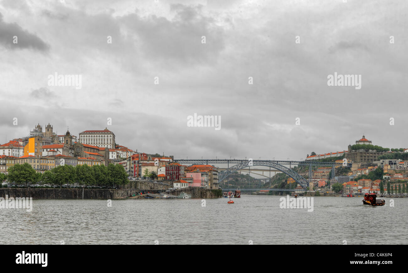 Panorama old Porto river Duoro,with boats, old town, town of Gaia and famous bridge Ponte dom Luis, Oporto, Portugal Stock Photo