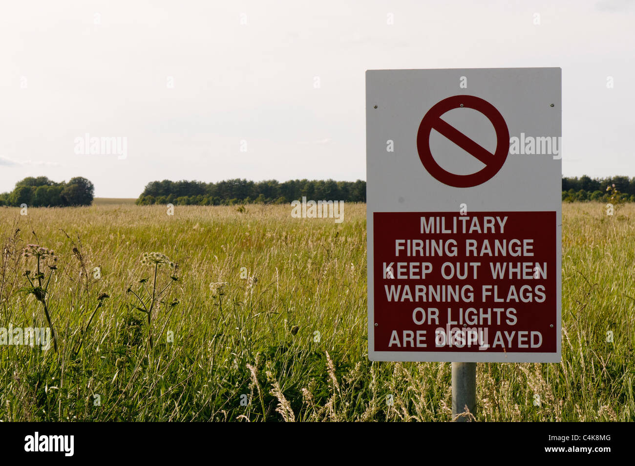 Sign 'Military firing range.  Keep out when warning flags or lights are displayed' Stock Photo
