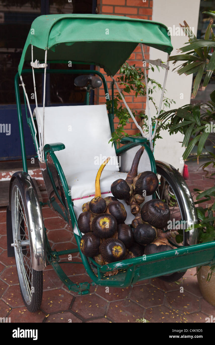 Cycle rickshaws are human-powered tricycles designed to carry passengers known as a cyclo in Cambodia. Stock Photo