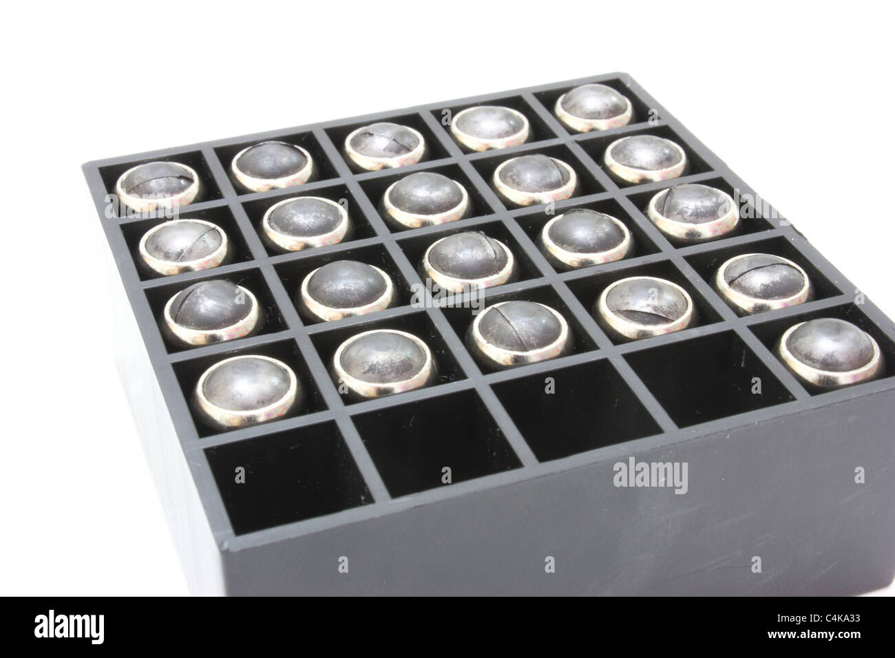 Pistol cartridges with a rubber bullet lie in packing of black color