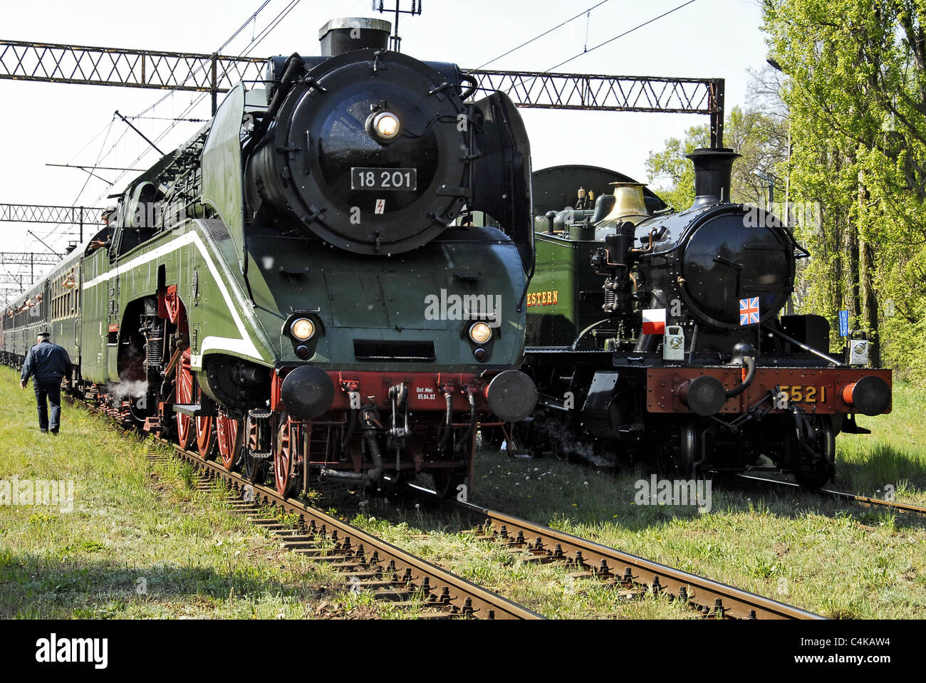 Large German steam loco along side much smaller British loco during May Day celebrations in Wolsztyn Poland Stock Photo