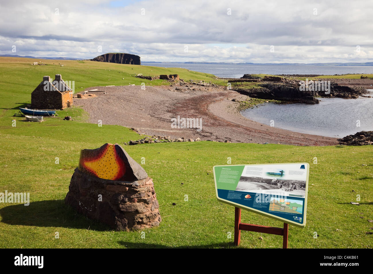 Tourist information board at old Haaf station with derelict fishing lodges around beach. Stenness, Eshaness, Shetland Islands, Scotland, UK. Stock Photo