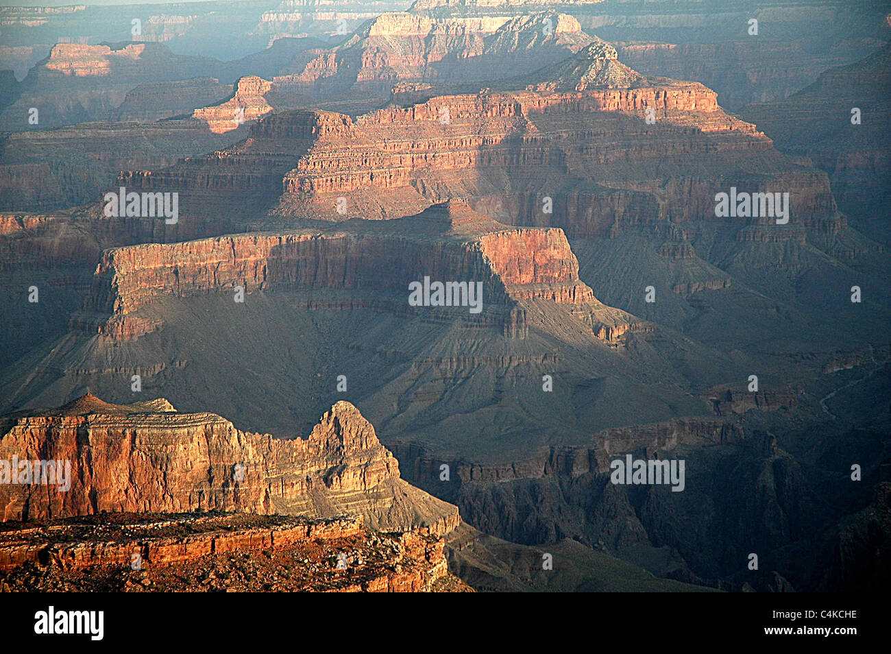 Sunrise highlights the mountains and crags of the Grand Canyon in Arizona. Stock Photo