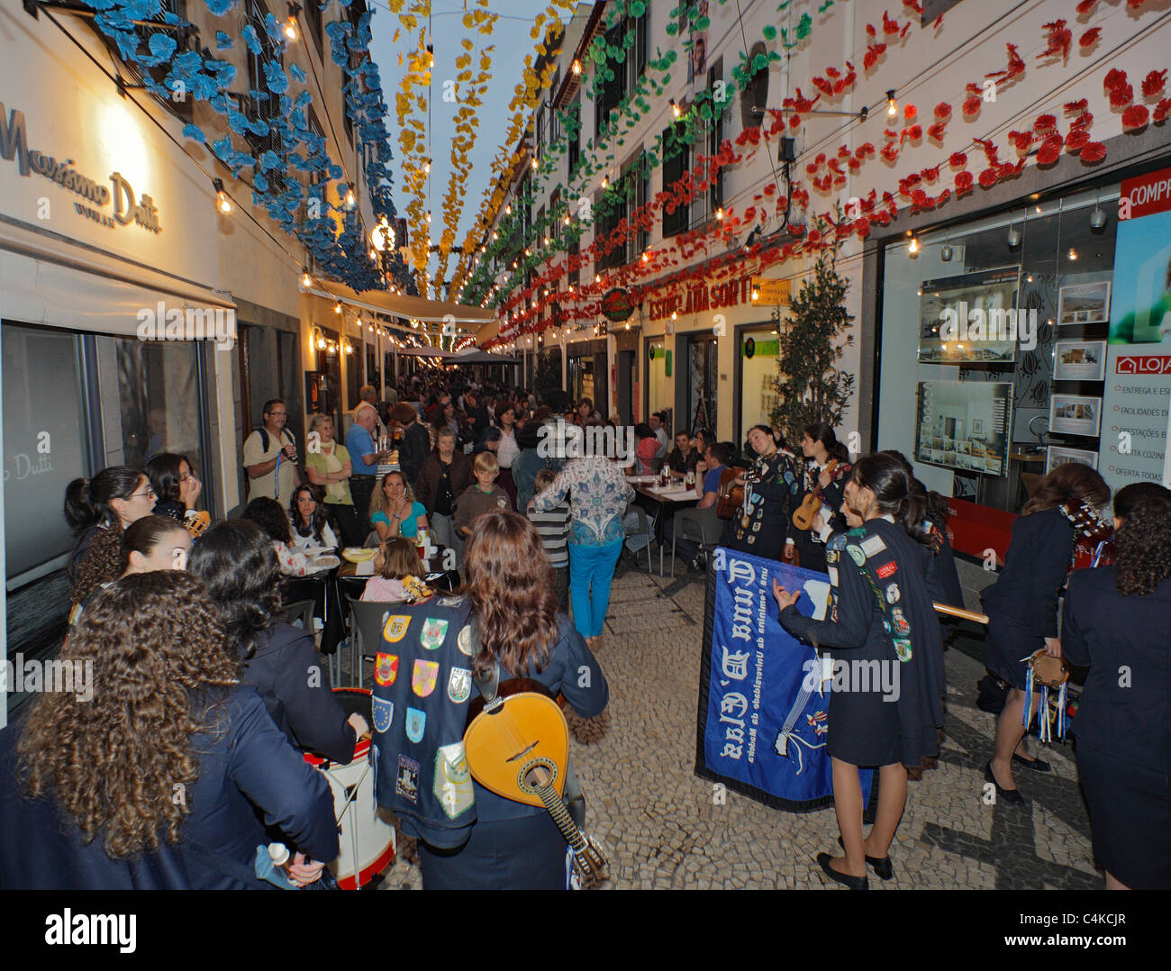 Female music band plays to restaurant goers in the old town Funchal, Madeira. Stock Photo