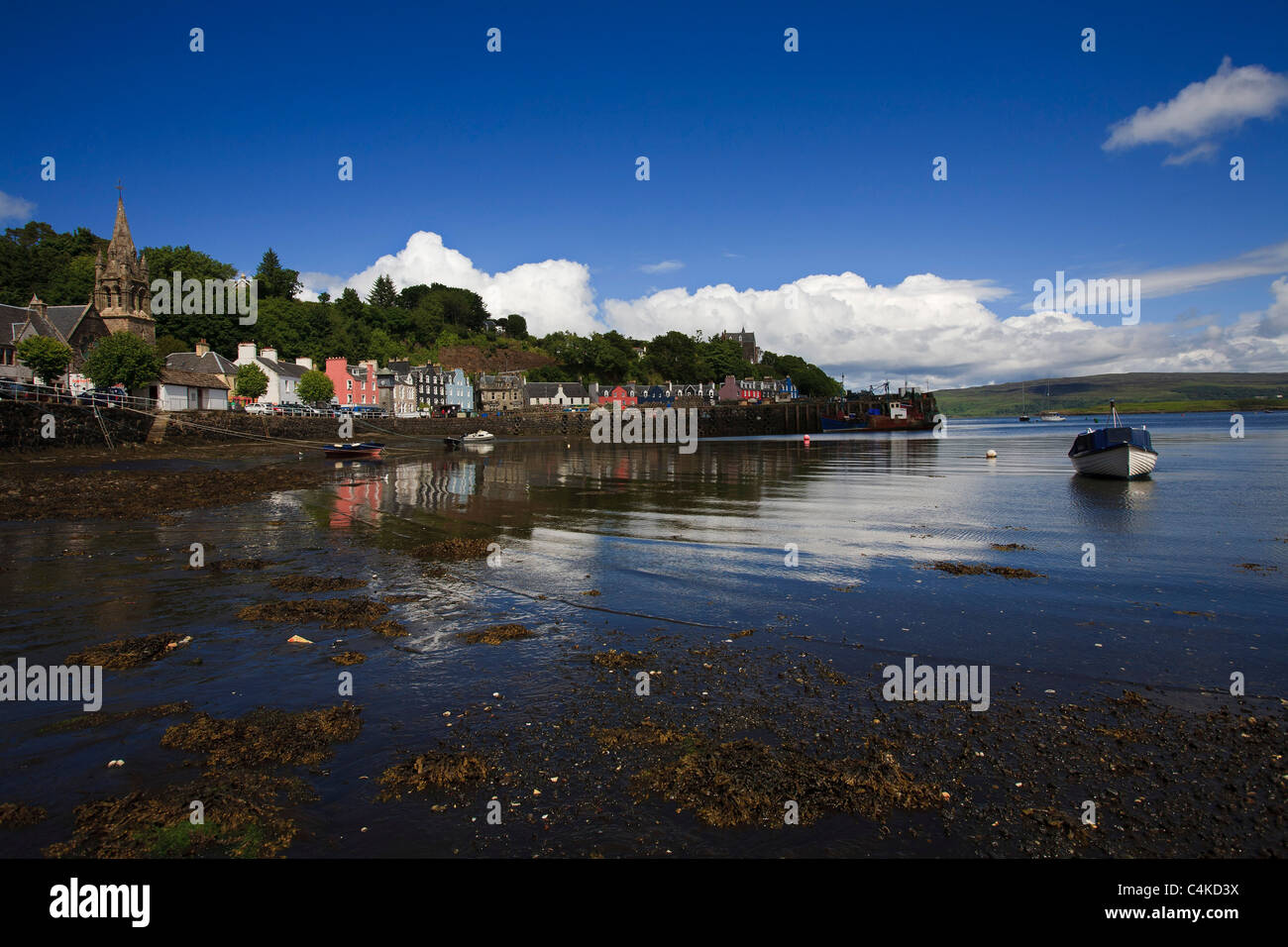A small boat at low tide in the harbour at Tobermory on the Isle of Mull, Inner Hebrides. Stock Photo