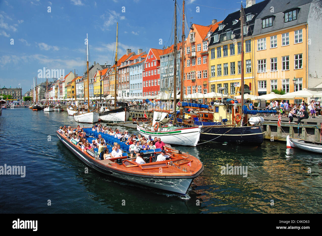 Canal boat cruise on colourful 17th century waterfront, Nyhavn Canal, Copenhagen (Kobenhavn), Kingdom of Denmark Stock Photo