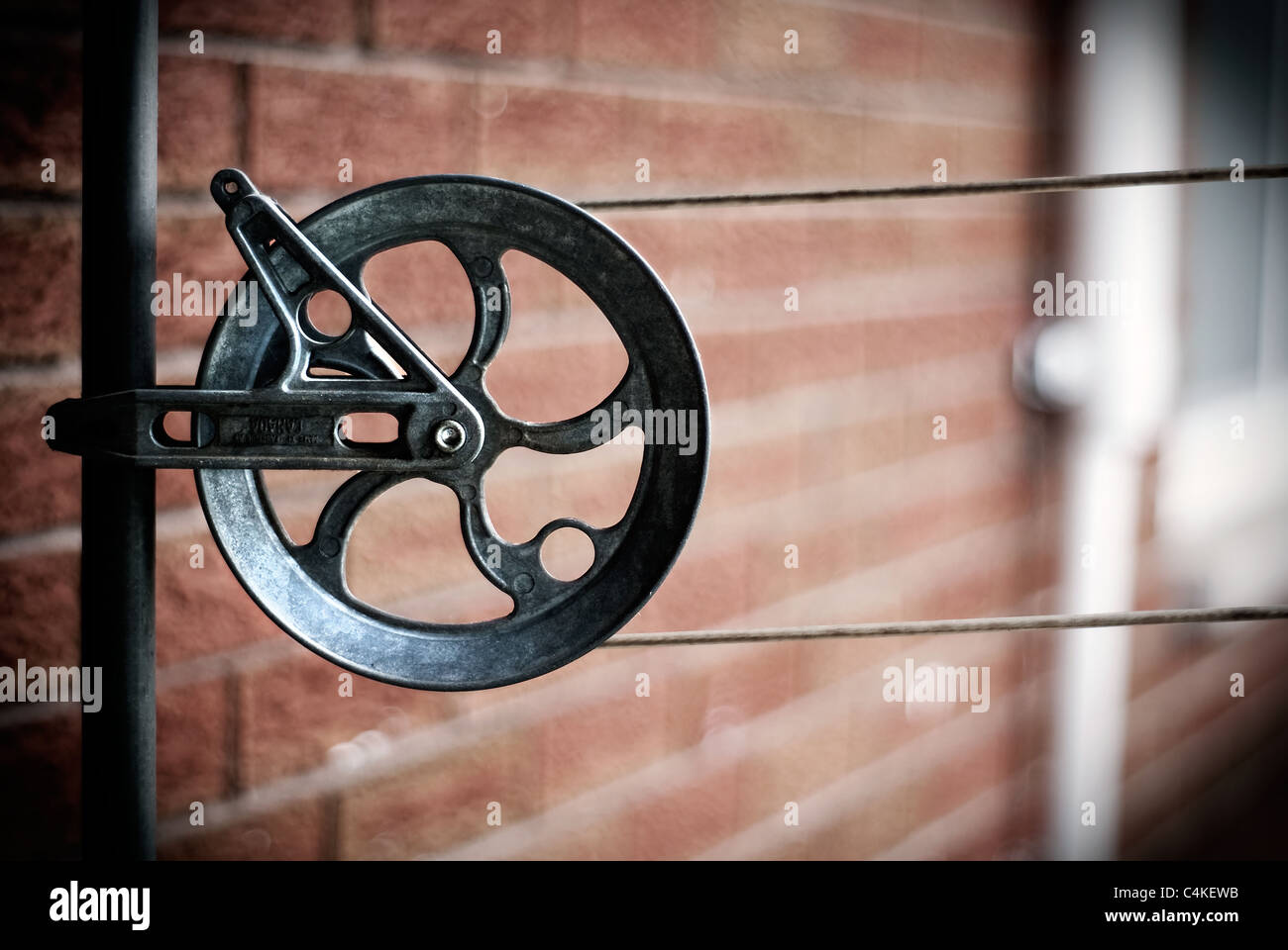 Close-up image of an old, steel clothesline pulley. Stock Photo