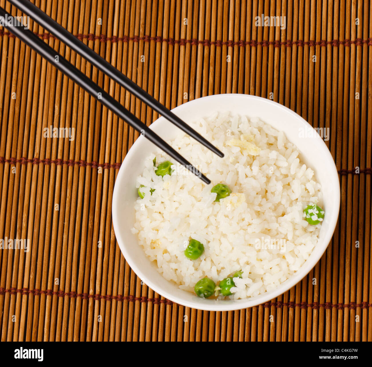 A bowl of egg fried rice with a pair of chopsticks in shoot Stock Photo