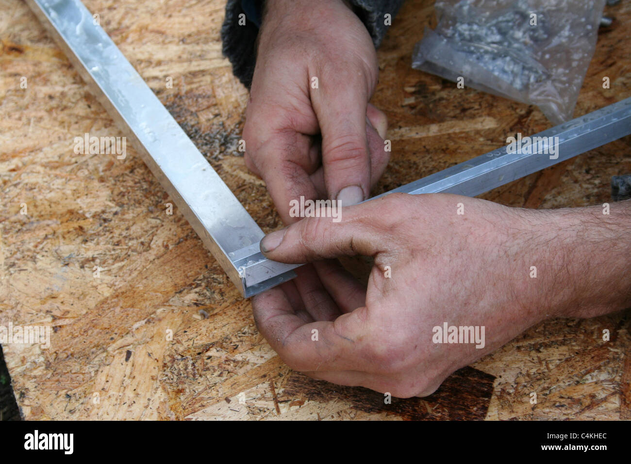 Gardener putting together a glass cold frame. Stock Photo